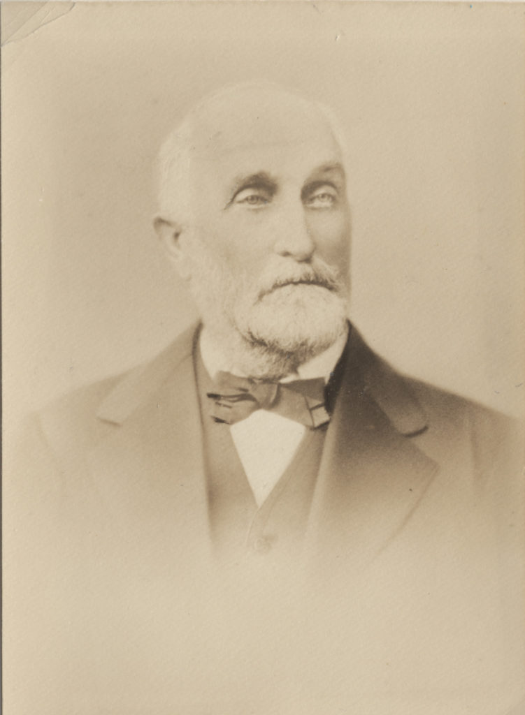This is a copy of a photograph of Charles Trumbull Hayden, a man with white hair, mustache and beard, and wearing a coat, vest, and bow tie. Courtesy of the Tempe History Museum.