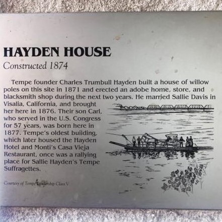 This photo shows the silver metal plaque outside Hayden House.