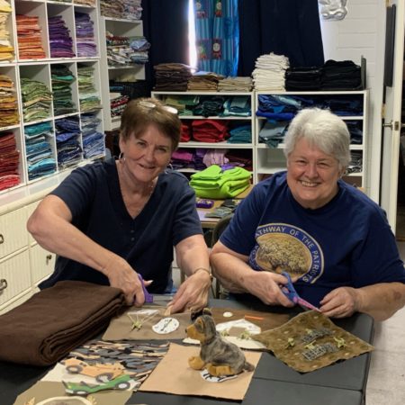 This photo shows two members of Charles Trumbull Hayden Chapter, NSDAR, assembling quilt squares of a fidget quilt.