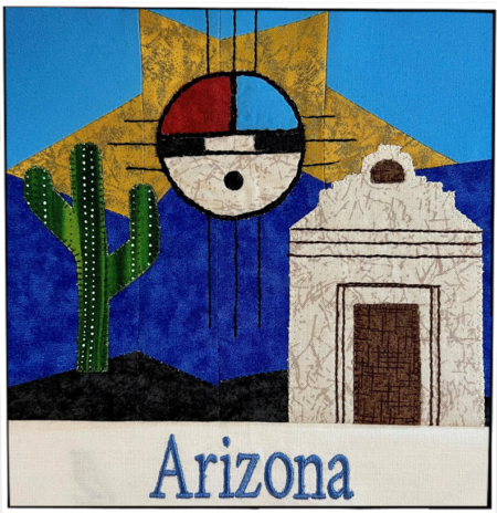 This photo shows a quilt block representing the state of Arizona. It contains a saguaro cactus, a white mission building, and a Native American sun design.